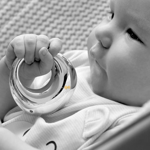 Garrard Christening New Baby Gift Baby Bee collection Sterling Silver Rattle 2017565held by a Baby