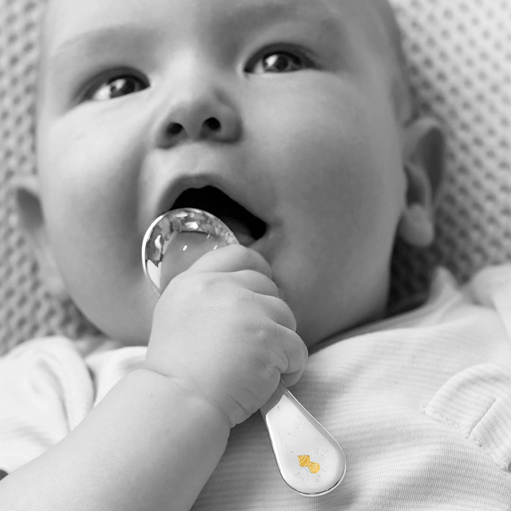 Garrard Christening New Baby Gift Baby Bee collection Sterling Silver Spoon 2017797 held by a Baby