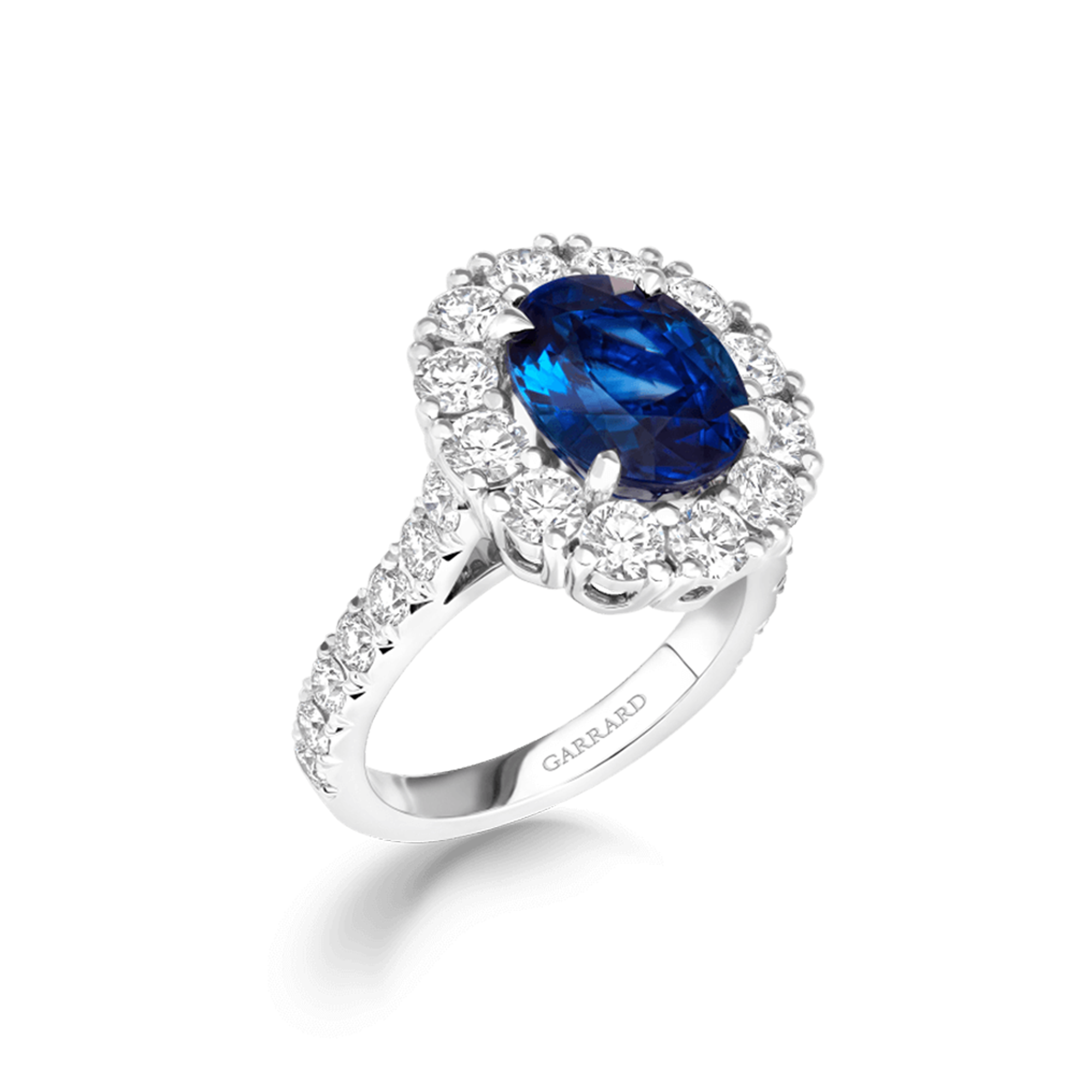 Jewelled Vault 5.05cts Oval Royal Blue Sapphire and Diamond Cluster Ring | In Platinum