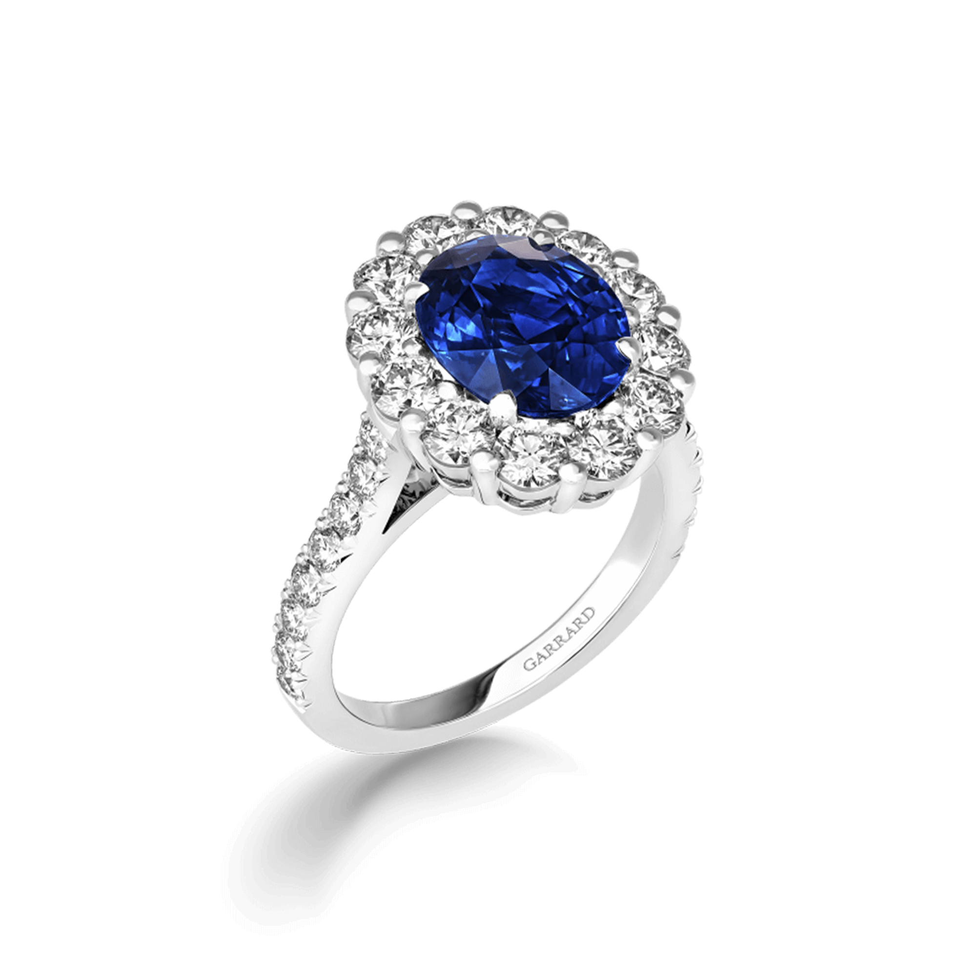 Jewelled Vault 6.70cts Oval Royal Blue Sapphire and Diamond Cluster Ring | In Platinum