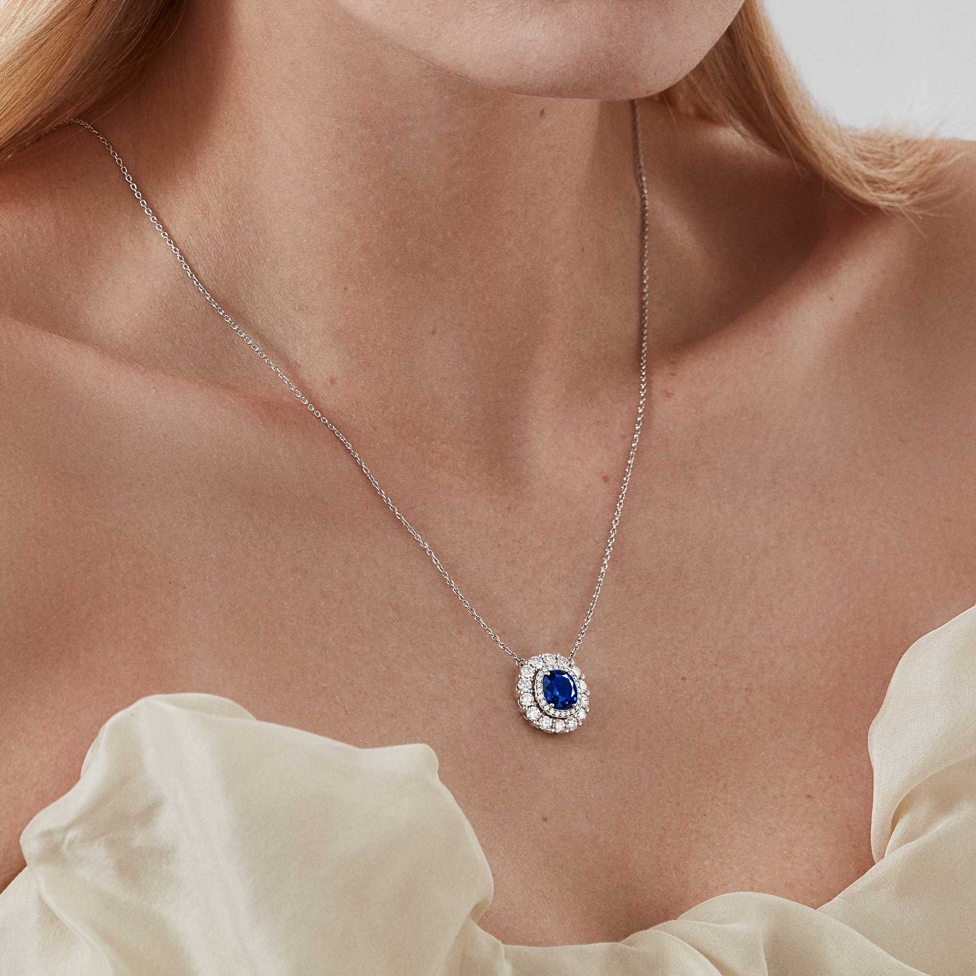 Garrard Jewelled Vault pendant with a central cushion cut sapphire with a round white diamond double surround 2017704 model